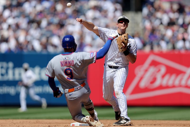 May 17, 2025; Bronx, New York, USA; New York Yankees second baseman DJ LeMahieu (26) forces out New York Mets left fielder Brandon Nimmo (9) at second base and throws to first to complete a double play on a ball hit by Mets designated hitter Mark Vientos (not pictured) during the sixth inning at Yankee Stadium. Mandatory Credit: Brad Penner-Imagn Images