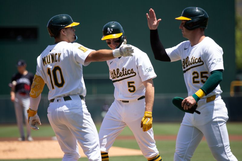 Jun 5, 2025; West Sacramento, California, USA; Athletics third baseman Max Muncy (10) is greeted by his teammates Jacob Wilson (5) and Brent Rooker (25) after hitting a three-run home run against the Minnesota Twins during the first inning at Sutter Health Park. Mandatory Credit: D. Ross Cameron-Imagn Images