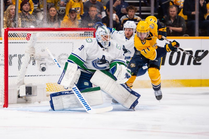 Apr 26, 2024; Nashville, Tennessee, USA; Vancouver Canucks goaltender Casey DeSmith (29) blocks the shot of Nashville Predators right wing Luke Evangelista (77) during the first period in game three of the first round of the 2024 Stanley Cup Playoffs at Bridgestone Arena. Mandatory Credit: Steve Roberts-USA TODAY Sports