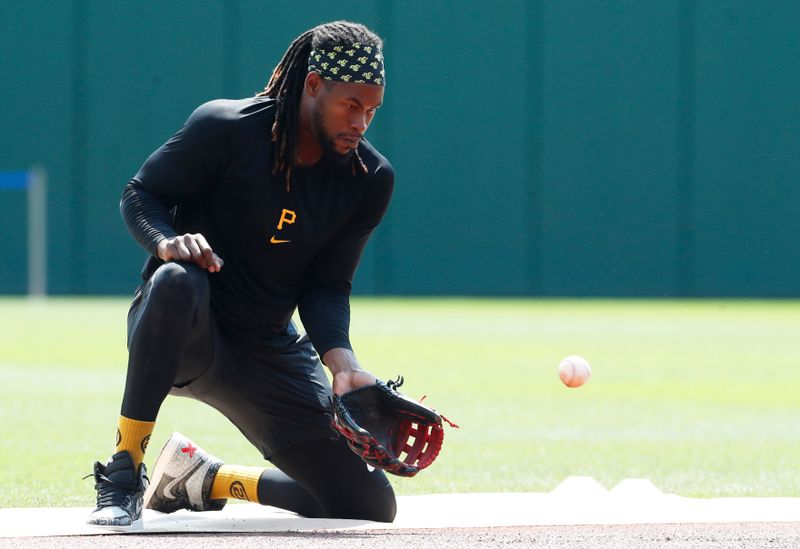 Aug 4, 2024; Pittsburgh, Pennsylvania, USA;  Pittsburgh Pirates shortstop Oneil Cruz (15) fields ground balls before the game against the Arizona Diamondbacks at PNC Park. Mandatory Credit: Charles LeClaire-USA TODAY Sports
