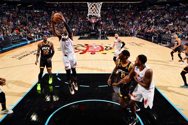 PHOENIX, AZ - JANUARY 6: Bam Adebayo #13 of the Miami Heat rebounds the ball during the game against the Phoenix Suns on January 6, 2023 at Footprint Center in Phoenix, Arizona. NOTE TO USER: User expressly acknowledges and agrees that, by downloading and or using this photograph, user is consenting to the terms and conditions of the Getty Images License Agreement. Mandatory Copyright Notice: Copyright 2022 NBAE (Photo by Barry Gossage/NBAE via Getty Images)