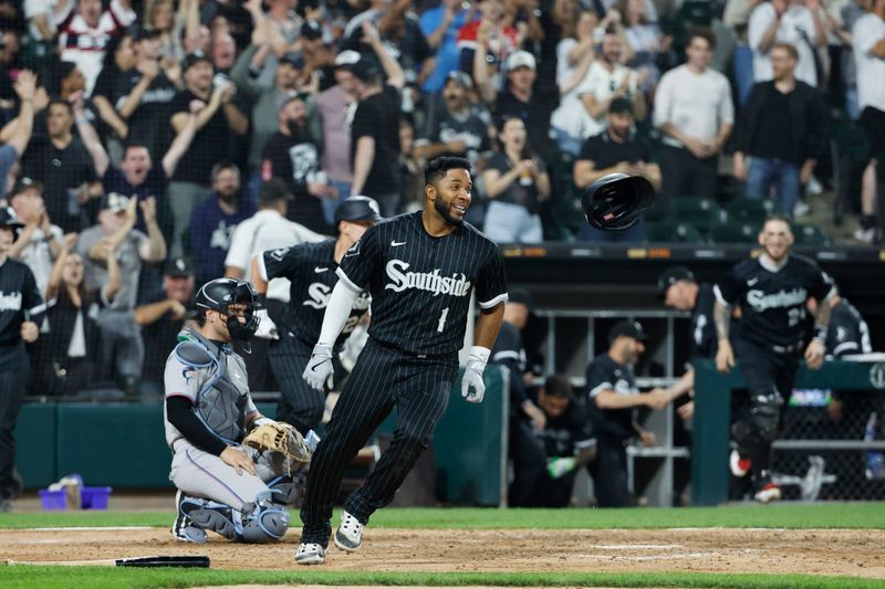 Jun 9, 2023; Chicago, Illinois, USA; Chicago White Sox shortstop Elvis Andrus (1) celebrates after scoring on a game winning single hit by Chicago White Sox center fielder Luis Robert Jr. (not pictured) against the Miami Marlins in the ninth inning at Guaranteed Rate Field. Mandatory Credit: Kamil Krzaczynski-USA TODAY Sports