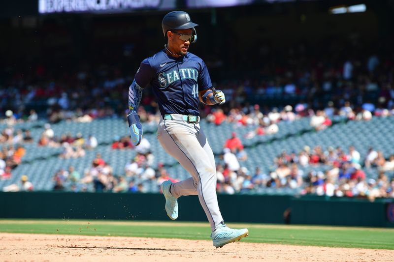 Jul 14, 2024; Anaheim, California, USA; Seattle Mariners center fielder Julio Rodriguez (44) reaches third against the Los Angeles Angels during the eighth inning at Angel Stadium. Mandatory Credit: Gary A. Vasquez-USA TODAY Sports