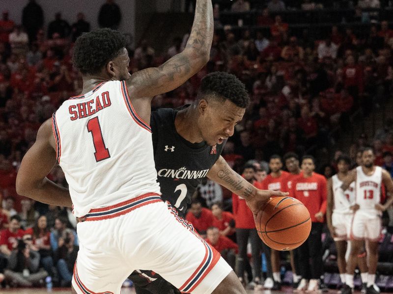 Jan 28, 2023; Houston, Texas, USA; Cincinnati Bearcats guard Landers Nolley II (2) dribbles against Houston Cougars guard Jamal Shead (1) in the second half at Fertitta Center. Houston Cougars won 75 to 69 .Mandatory Credit: Thomas Shea-USA TODAY Sports