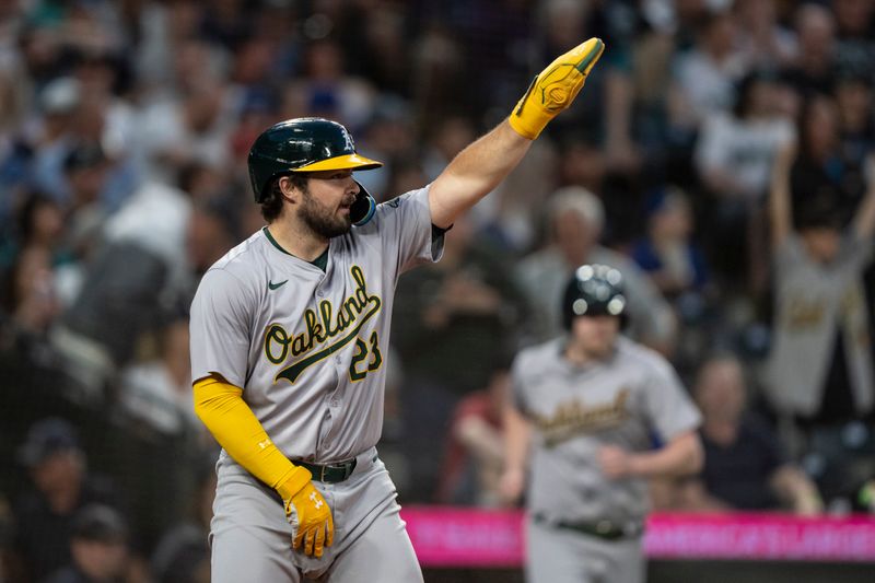 May 11, 2024; Seattle, Washington, USA; Oakland Athletics catcher Shea Langeliers (23) celebrates after scoring a run during the eighth inning against the Seattle Mariners at T-Mobile Park. Mandatory Credit: Stephen Brashear-USA TODAY Sports