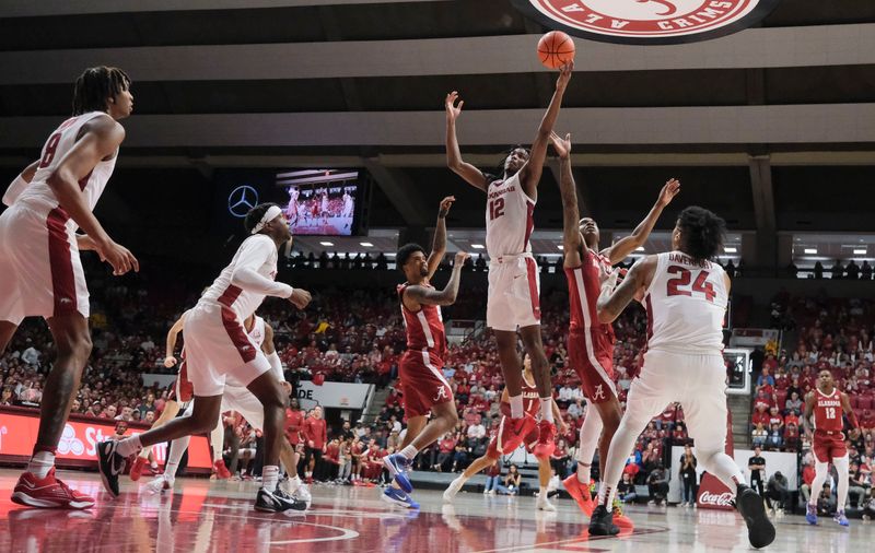 Mar 9, 2024; Tuscaloosa, Alabama, USA;  Arkansas guard Tramon Mark (12) grabs a rebound over Alabama forward Nick Pringle (23) and Alabama guard Aaron Estrada at Coleman Coliseum. Alabama came from behind to win on overtime 92-88. Mandatory Credit: Gary Cosby Jr.-USA TODAY Sports