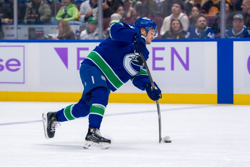 Nov 17, 2024; Vancouver, British Columbia, CAN; Vancouver Canucks defenseman Erik Brannstrom (26) scores on the shot against the Nashville Predators during the first period at Rogers Arena. Mandatory Credit: Bob Frid-Imagn Images