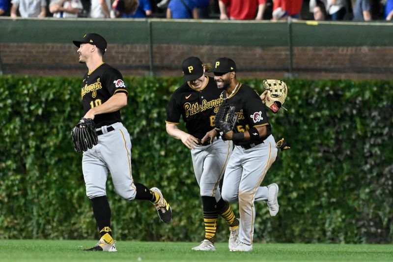 Sep 20, 2023; Chicago, Illinois, USA; Pittsburgh Pirates left fielder Bryan Reynolds (10) and Pittsburgh Pirates center fielder Jack Suwinski (65) celebrate with  Pittsburgh Pirates right fielder Joshua Palacios (54) after their game against the Chicago Cubs at Wrigley Field. Mandatory Credit: Matt Marton-USA TODAY Sports