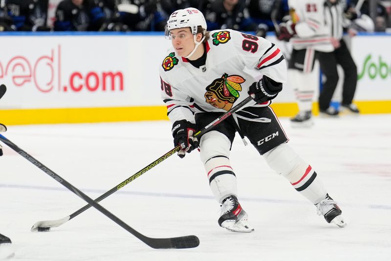 Dec 2, 2024; Toronto, Ontario, CAN; Chicago Blackhawks forward Connor Bedard (98) carries the puck against the Toronto Maple Leafs during the second period at Scotiabank Arena. Mandatory Credit: John E. Sokolowski-Imagn Images