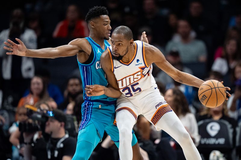 CHARLOTTE, NORTH CAROLINA - MARCH 15: Brandon Miller #24 of the Charlotte Hornets guards Kevin Durant #35 of the Phoenix Suns in the second quarter during their game at Spectrum Center on March 15, 2024 in Charlotte, North Carolina. NOTE TO USER: User expressly acknowledges and agrees that, by downloading and or using this photograph, User is consenting to the terms and conditions of the Getty Images License Agreement. (Photo by Jacob Kupferman/Getty Images)