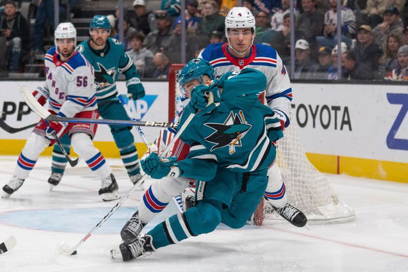 Jan 23, 2024; San Jose, California, USA; San Jose Sharks right wing Justin Bailey (90) attempts to maintain control of the puck during the second period against New York Rangers defenseman Braden Schneider (4) at SAP Center at San Jose. Mandatory Credit: Stan Szeto-USA TODAY Sports