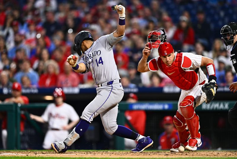 Apr 16, 2024; Philadelphia, Pennsylvania, USA; Philadelphia Phillies catcher J.T. Realmuto (10) chases the ball after Colorado Rockies shortstop Ezequiel Tovar (14) strikes out in the sixth inning at Citizens Bank Park. Mandatory Credit: Kyle Ross-USA TODAY Sports