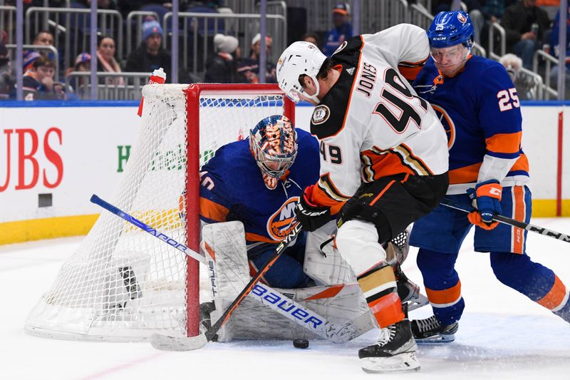 Dec 13, 2023; Elmont, New York, USA; New York Islanders goaltender Semyon Varlamov (40) makes a save on Anaheim Ducks left wing Max Jones (49) defended by New York Islanders defenseman Sebastian Aho (25) during the third period at UBS Arena. Mandatory Credit: Dennis Schneidler-USA TODAY Sports