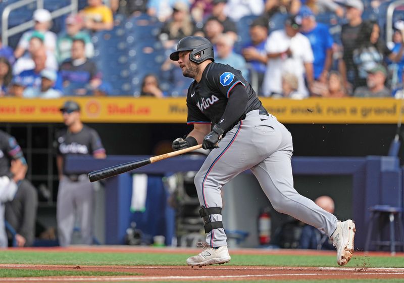 Sep 29, 2024; Toronto, Ontario, CAN; Miami Marlins designated hitter Jake Burger (36) hits a single against the Toronto Blue Jays during the first inning at Rogers Centre. Mandatory Credit: Nick Turchiaro-Imagn Images