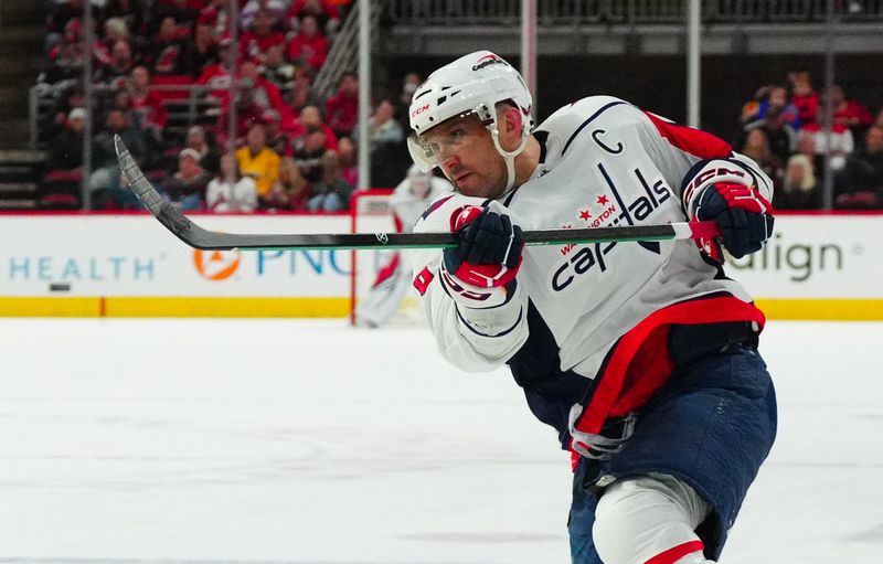 Apr 5, 2024; Raleigh, North Carolina, USA; Washington Capitals left wing Alex Ovechkin (8) takes a shot against the Carolina Hurricanes during the second period at PNC Arena. Mandatory Credit: James Guillory-USA TODAY Sports