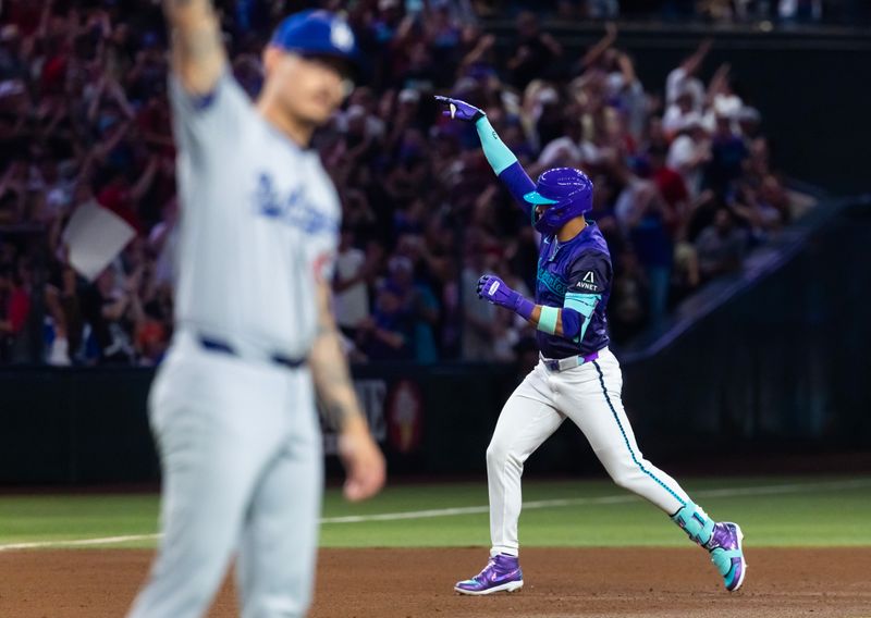 May 9, 2025; Phoenix, Arizona, USA; Arizona Diamondbacks outfielder Lourdes Gurriel Jr. celebrates as he rounds the bases after hitting a grand slam home run in the fifth inning against Los Angeles Dodgers pitcher Anthony Banda at Chase Field. Mandatory Credit: Mark J. Rebilas-Imagn Images