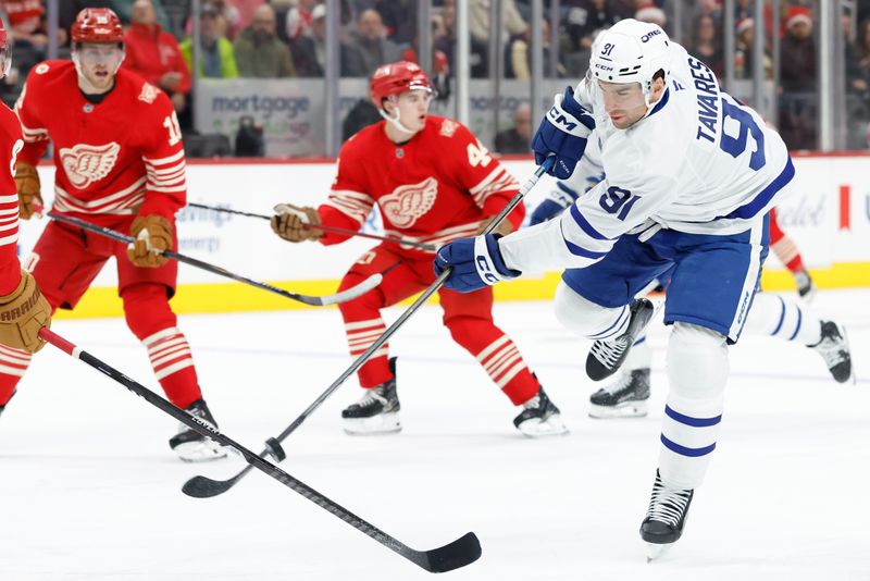 Dec 28, 2025; Detroit, Michigan, USA;  Toronto Maple Leafs center John Tavares (91) takes a shot in the first period against the Detroit Red Wings at Little Caesars Arena. Mandatory Credit: Rick Osentoski-Imagn Images