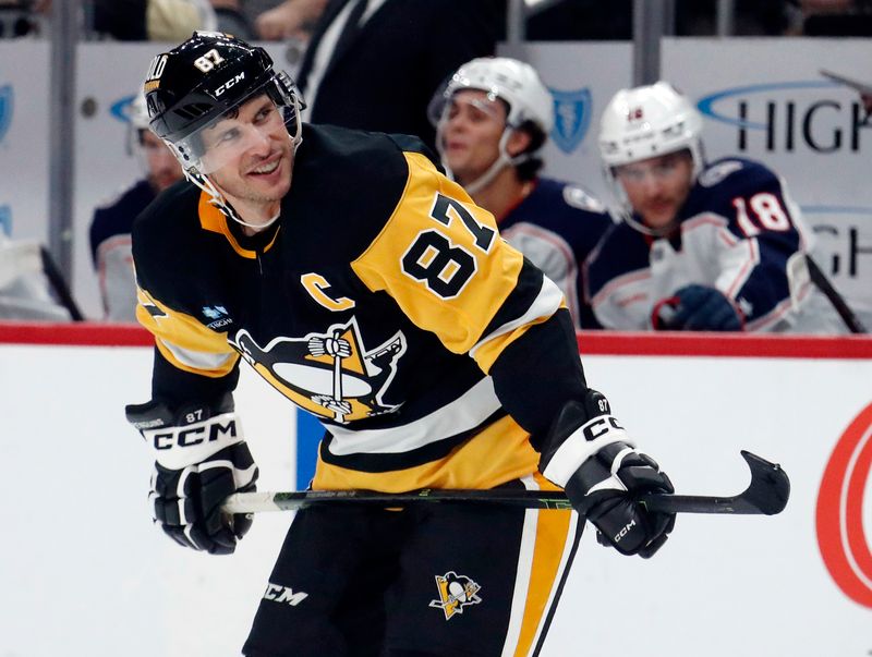 Oct 4, 2024; Pittsburgh, Pennsylvania, USA;  Pittsburgh Penguins center Sidney Crosby (87) reacts on the ice against the Columbus Blue Jackets during the second period at PPG Paints Arena. Mandatory Credit: Charles LeClaire-Imagn Images