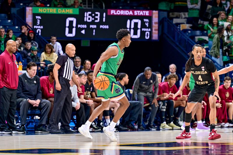 Jan 17, 2023; South Bend, Indiana, USA; Notre Dame Fighting Irish guard Marcus Hammond (10) dribbles as Florida State Seminoles guard Caleb Mills (4) defends in the first half at the Purcell Pavilion. Mandatory Credit: Matt Cashore-USA TODAY Sports