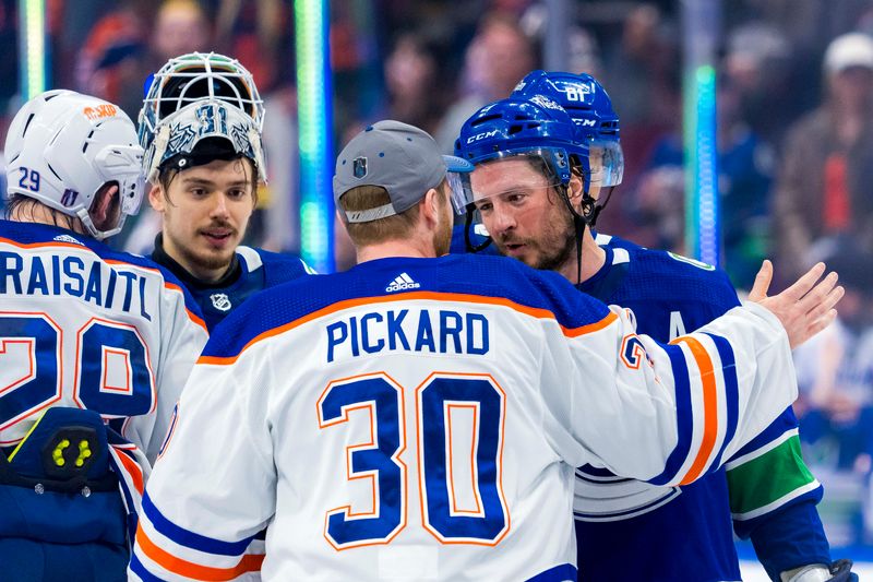 May 20, 2024; Vancouver, British Columbia, CAN; Vancouver Canucks forward J.T. Miller (9) shakes hands with Edmonton Oilers goalie Calvin Pickard (30) after the Edmonton victory in game seven of the second round of the 2024 Stanley Cup Playoffs at Rogers Arena. Mandatory Credit: Bob Frid-USA TODAY Sports