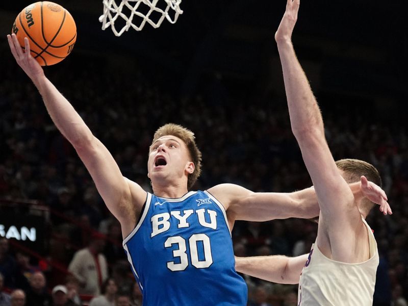 Feb 27, 2024; Lawrence, Kansas, USA; Brigham Young Cougars guard Dallin Hall (30) shoots a layup as Kansas Jayhawks guard Johnny Furphy (10) defends during the first half at Allen Fieldhouse. Mandatory Credit: Denny Medley-USA TODAY Sports