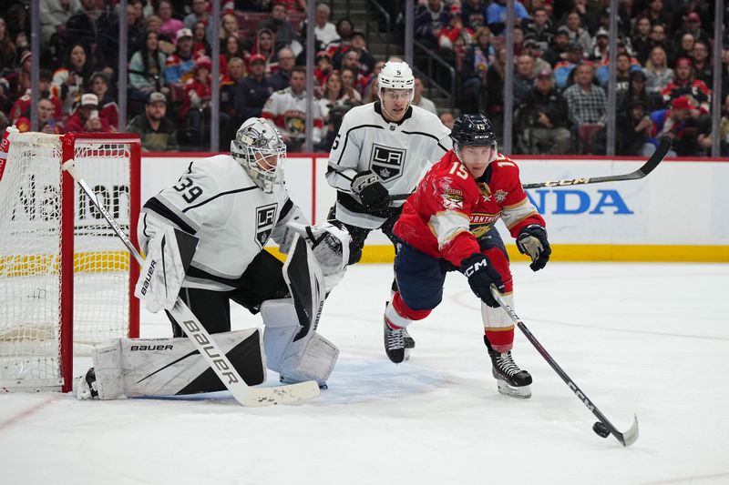 Jan 11, 2024; Sunrise, Florida, USA; Florida Panthers center Anton Lundell (15) reaches for the puck in front of Los Angeles Kings goaltender Cam Talbot (39) during the second period at Amerant Bank Arena. Mandatory Credit: Jasen Vinlove-USA TODAY Sports