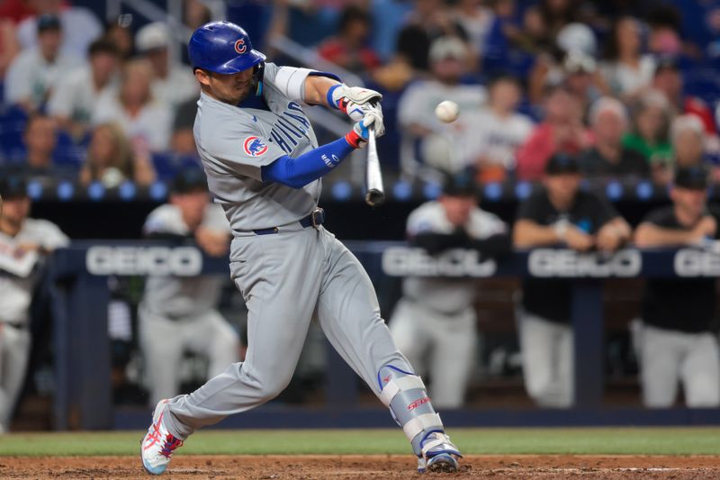 May 20, 2025; Miami, Florida, USA; Chicago Cubs right fielder Seiya Suzuki (27) hits a two-run home run against the Miami Marlins during the sixth inning at loanDepot Park. Mandatory Credit: Sam Navarro-Imagn Images