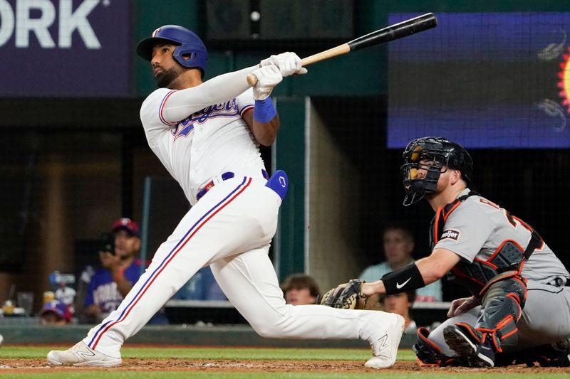 Jun 29, 2023; Arlington, Texas, USA; Texas Rangers shortstop Ezequiel Duran (20) follows thru on a solo home run during the fourth inning against the Detroit Tigers at Globe Life Field. Mandatory Credit: Raymond Carlin III-USA TODAY Sports