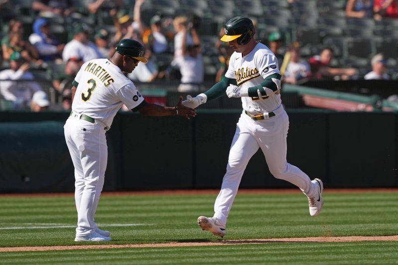 Sep 17, 2023; Oakland, California, USA; Oakland Athletics designated hitter Brent Rooker (right) celebrates with third base coach Eric Martins (3) after hitting a home run against the San Diego Padres during the ninth inning at Oakland-Alameda County Coliseum. Mandatory Credit: Darren Yamashita-USA TODAY Sports