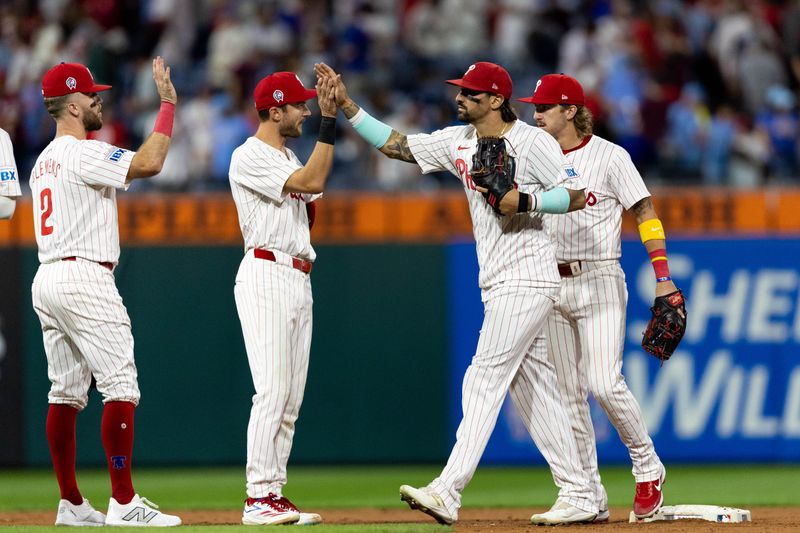 Sep 11, 2024; Philadelphia, Pennsylvania, USA; Philadelphia Phillies outfielder Nick Castellanos (8) high fives shortstop Trea Turner (7) after a victory against the Tampa Bay Rays at Citizens Bank Park. Mandatory Credit: Bill Streicher-Imagn Images