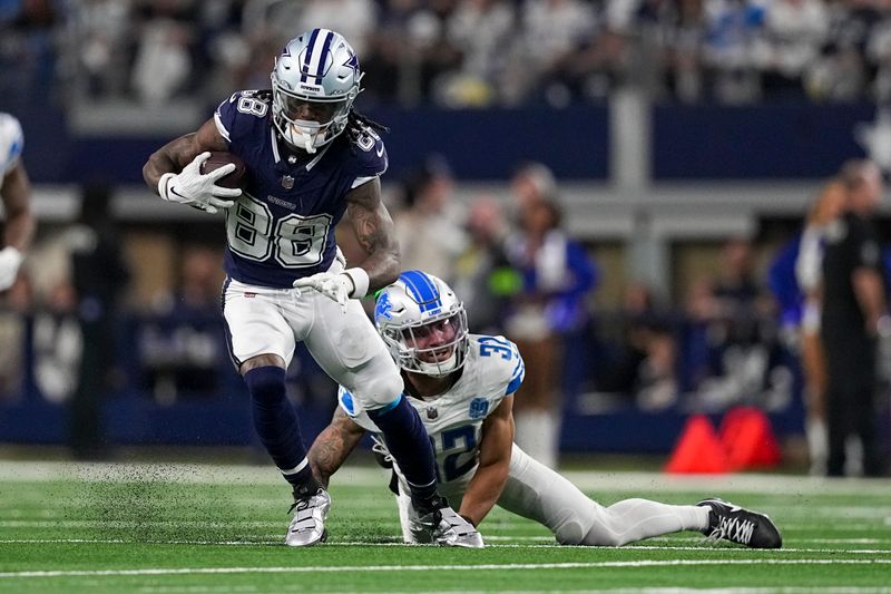 Dallas Cowboys wide receiver CeeDee Lamb (88) runs with the ball as Detroit Lions safety Brian Branch (32) tries to stop him during the second half of an NFL football game, Saturday, Dec. 30, 2023, in Arlington, Texas. (AP Photo/Sam Hodde)