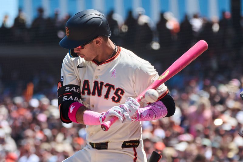 May 12, 2024; San Francisco, California, USA; San Francisco Giants catcher Blake Sabol (21) is hit by a pitch against the Cincinnati Reds during the fourth inning at Oracle Park. Mandatory Credit: Robert Edwards-USA TODAY Sports