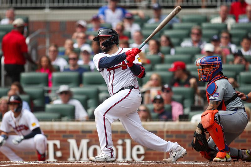 Sep 30, 2024; Atlanta, Georgia, USA; Atlanta Braves catcher Travis d'Arnaud (16) hits a single against the New York Mets in the second inning at Truist Park. Mandatory Credit: Brett Davis-Imagn Images
