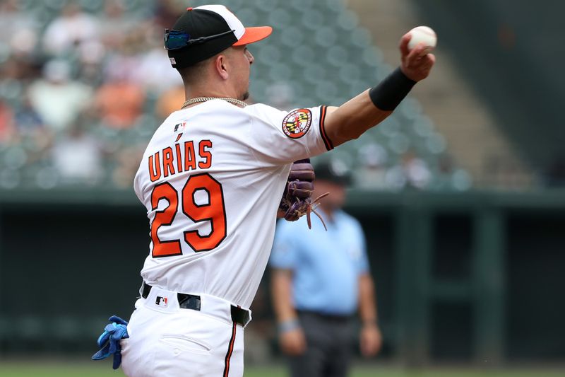 Jun 29, 2025; Baltimore, Maryland, USA; Baltimore Orioles third baseman Ramon Urias (29) throws to first for an out during the third inning against the Tampa Bay Rays at Oriole Park at Camden Yards. Mandatory Credit: Daniel Kucin Jr.-Imagn Images