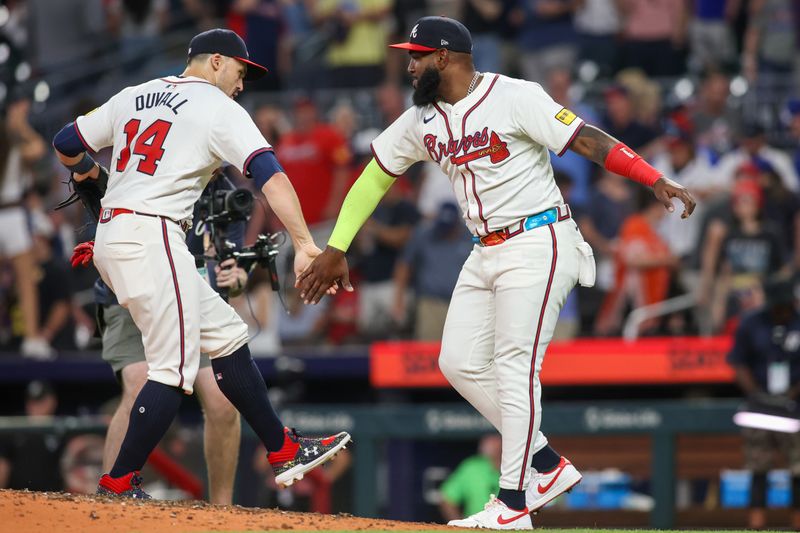 May 8, 2024; Atlanta, Georgia, USA; Atlanta Braves left fielder Adam Duvall (14) and designated hitter Marcell Ozuna (20) celebrate after a victory against the Boston Red Sox at Truist Park. Mandatory Credit: Brett Davis-USA TODAY Sports
