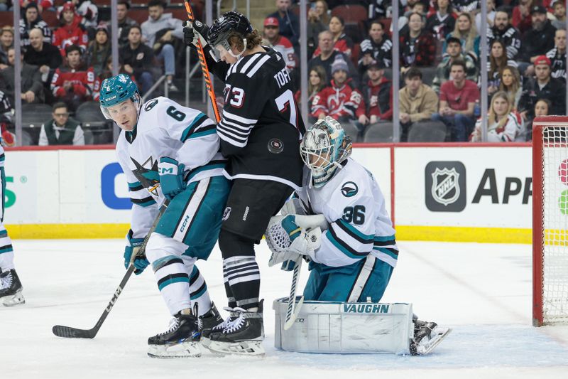 Dec 1, 2023; Newark, New Jersey, USA; New Jersey Devils right wing Tyler Toffoli (73) screens San Jose Sharks goaltender Kaapo Kahkonen (36) during a shot as defenseman Ty Emberson (6) defends during the first period at Prudential Center. Mandatory Credit: Vincent Carchietta-USA TODAY Sports