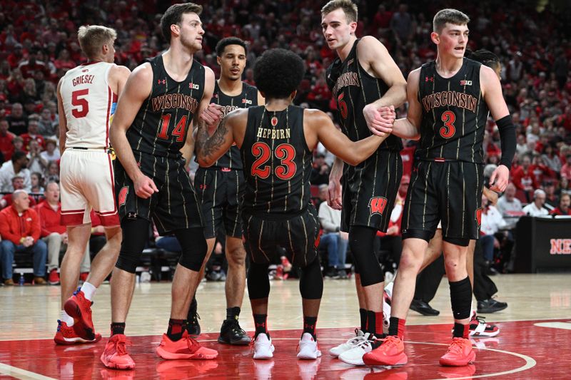 Feb 11, 2023; Lincoln, Nebraska, USA;  Wisconsin Badgers forward Carter Gilmore (14) and forward Tyler Wahl (5) lift guard Chucky Hepburn (23) up after a foul call against the Nebraska Cornhuskers in the first half at Pinnacle Bank Arena. Mandatory Credit: Steven Branscombe-USA TODAY Sports