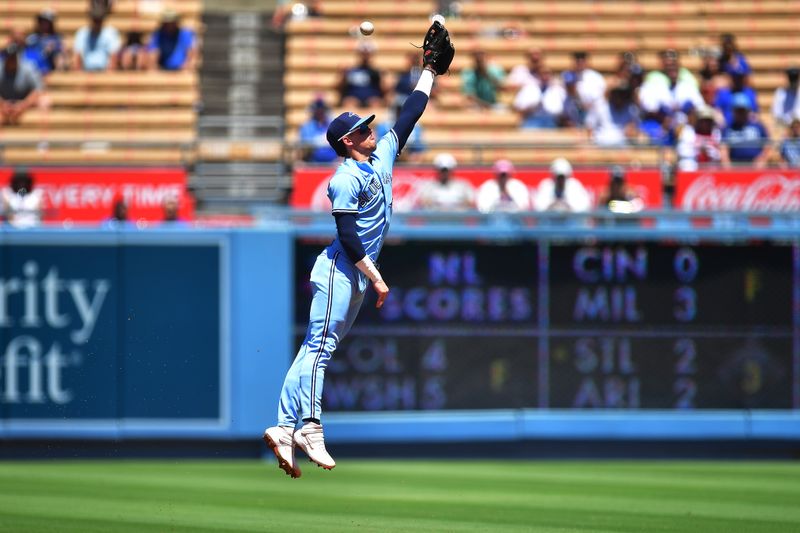 Jul 26, 2023; Los Angeles, California, USA; Toronto Blue Jays second baseman Cavan Biggio (8) misses catching the single of Los Angeles Dodgers center fielder James Outman (33) during the second inning at Dodger Stadium. Mandatory Credit: Gary A. Vasquez-USA TODAY Sports