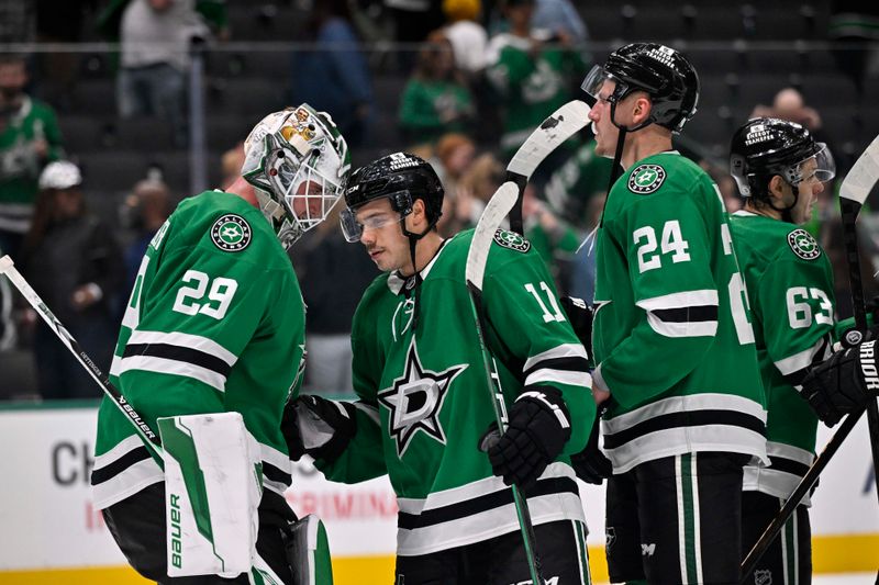 Nov 7, 2024; Dallas, Texas, USA; Dallas Stars goaltender Jake Oettinger (29) and center Logan Stankoven (11) and center Roope Hintz (24) celebrate the Stars victory of the Chicago Blackhawks at the American Airlines Center. Mandatory Credit: Jerome Miron-Imagn Images