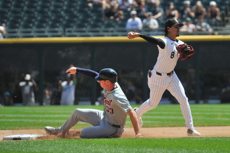 Aug 25, 2024; Chicago, Illinois, USA; Chicago White Sox shortstop Nicky Lopez (8) completes a double play after forcing out Detroit Tigers second base Colt Keith (33) during the first inning at Guaranteed Rate Field. Mandatory Credit: Patrick Gorski-USA TODAY Sports