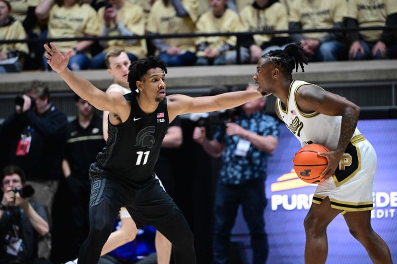 Mar 2, 2024; West Lafayette, Indiana, USA; Michigan State Spartans guard A.J. Hoggard (11) defends against Purdue Boilermakers guard Lance Jones (55) during the first half at Mackey Arena. Mandatory Credit: Marc Lebryk-USA TODAY Sports