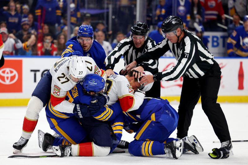 Oct 18, 2025; Buffalo, New York, USA;  The linesman try to break up a scrum between the Buffalo Sabres and the Florida Panthers in the second period at KeyBank Center. Mandatory Credit: Timothy T. Ludwig-Imagn Images