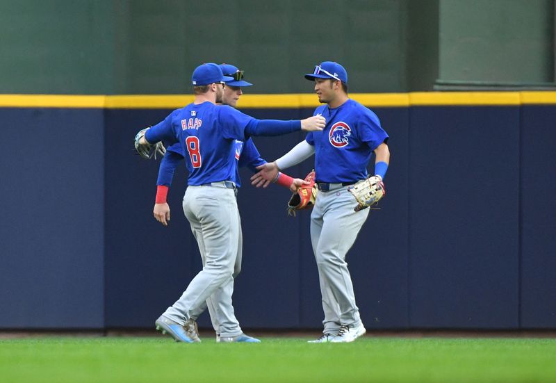 Jun 29, 2024; Milwaukee, Wisconsin, USA; Chicago Cubs outfielder Ian Happ (8), Chicago Cubs outfielder Pete Crow-Armstrong (52) and Chicago Cubs outfielder Seiya Suzuki (27) celebrate a 5-3 win over the Milwaukee Brewers at American Family Field. Mandatory Credit: Michael McLoone-USA TODAY Sports