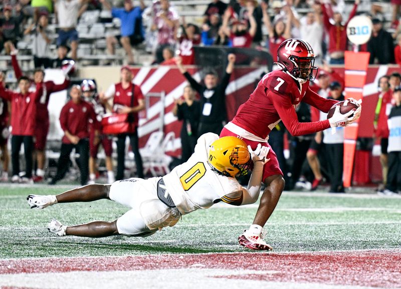 Sep 10, 2022; Bloomington, Indiana, USA;  Indiana Hoosiers wide receiver D.J. Matthews Jr. (7) catches a pass for a touchdown against Idaho Vandals defensive back Murvin Kenion III (0) during the second half at Memorial Stadium. The Hoosiers won 35-22.  Mandatory Credit: Marc Lebryk-USA TODAY Sports