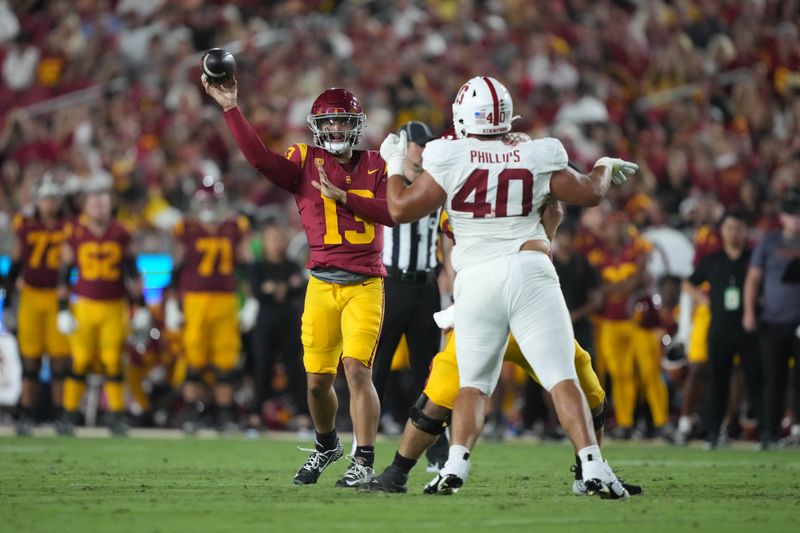 Sep 9, 2023; Los Angeles, California, USA; Southern California Trojans quarterback Caleb Williams (13) throws the ball against Stanford Cardinal defensive lineman Tobin Phillips (40) in the first half at United Airlines Field at Los Angeles Memorial Coliseum. Mandatory Credit: Kirby Lee-USA TODAY Sports