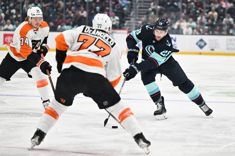 Feb 16, 2023; Seattle, Washington, USA; Seattle Kraken defenseman Carson Soucy (28) advances the puck while being defended by Philadelphia Flyers right wing Owen Tippett (74) and defenseman Tony DeAngelo (77) during the first period at Climate Pledge Arena. Mandatory Credit: Steven Bisig-USA TODAY Sports