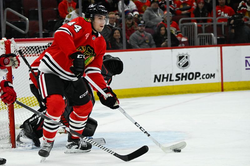 Jan 20, 2025; Chicago, Illinois, USA;   Chicago Blackhawks defenseman Wyatt Kaiser (44) moves the puck against the Carolina Hurricanes during the first period at the United Center. Mandatory Credit: Matt Marton-Imagn Images


