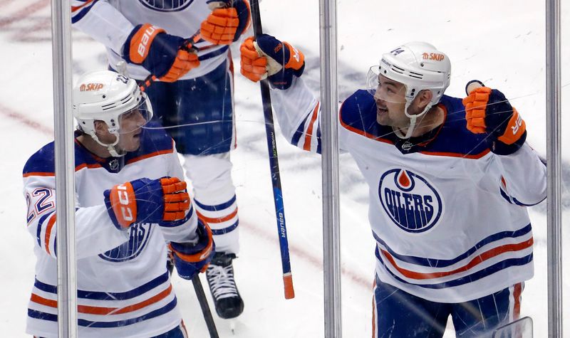 Feb 23, 2023; Pittsburgh, Pennsylvania, USA; Edmonton Oilers center Devin Shore (right) celebrates his goal with defenseman Tyson Barrie (22) against the Pittsburgh Penguins during the second period at PPG Paints Arena. Mandatory Credit: Charles LeClaire-USA TODAY Sports
