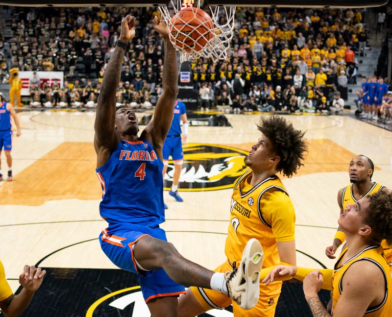 Jan 20, 2024; Columbia, Missouri, USA; Florida Gators forward Tyrese Samuel (4) dunks the ball against Missouri Tigers forward Jordan Butler (0) during the first half at Mizzou Arena. Mandatory Credit: Jay Biggerstaff-USA TODAY Sports