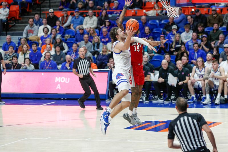 Jan 16, 2024; Boise, Idaho, USA; Boise State Broncos forward Tyson Degenhart (2) drives past UNLV Rebels guard Luis Rodriguez (15) during the second half at ExtraMile Arena. UNLV beats Boise State 68-64Mandatory Credit: Brian Losness-USA TODAY Sports



